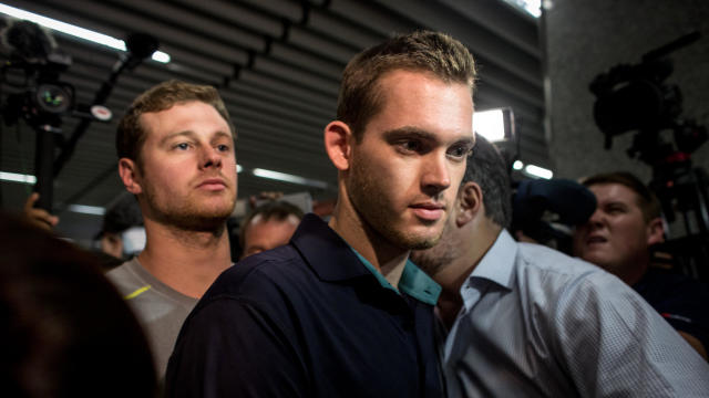 U.S. Olympic swimmers Gunnar Bentz, left, and Jack Conger leave police headquarters at the international departures terminal of Rio de Janiero’s Galeo international airport on Aug. 18, 2016, in Rio de Janiero, Brazil. 