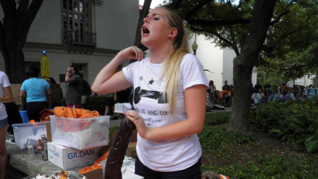 University of Texas student Rosie Zander holds a sex toy at a protest against a state law that allows guns in classrooms at college campuses 