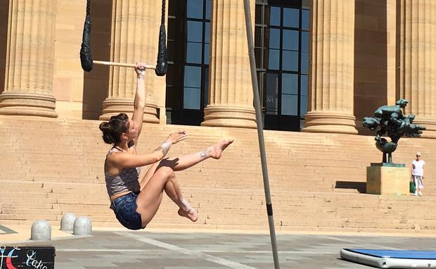 Nicole Burgio on trapeze on the steps of the Philadelphia Museum of Art 