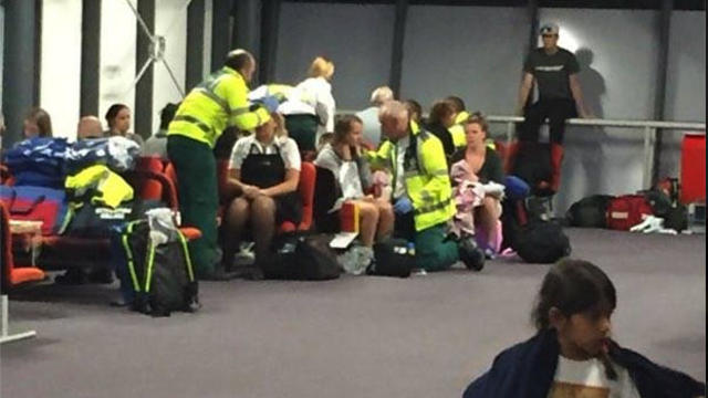 Emergency responders treat people who were onboard United Flight 880 after it made an emergency landing at Ireland’s Shannon Airport on Aug. 31, 2016. 