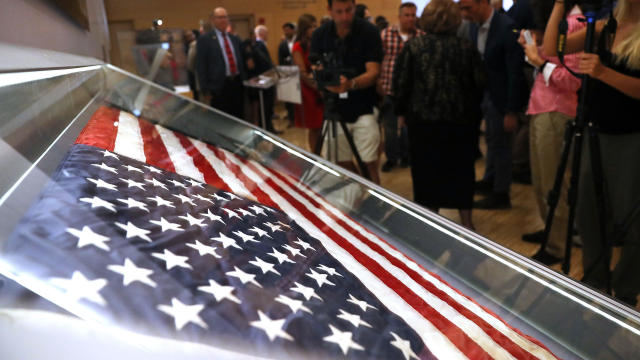 The American flag that was raised by firefighters above the site of the 9/11 attacks on the World Trade Center in New York in 2001 is displayed for the first time at the National September 11 Memorial & Museum after turning up in Washington state two year 