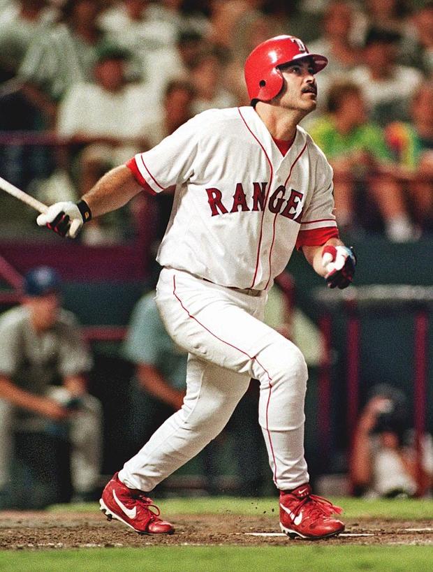 Rafael Palmeiro of the Texas Rangers watches his t 