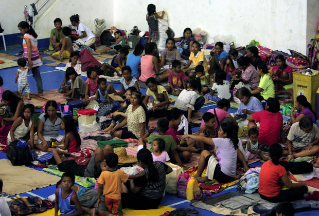 Evacuees from the coastal villages take shelter inside an evacuation center as Typhoon Haima approaches in Alcala, Philippines, Oct. 19, 2016. 