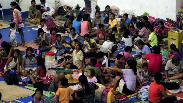 Evacuees from the coastal villages take shelter inside an evacuation center as Typhoon Haima approaches in Alcala, Philippines, Oct. 19, 2016. 