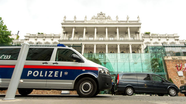 A police car passes in front of the Palais Coburg Hotel, the venue of the nuclear talks in Vienna, Austria, on June 27, 2015. 