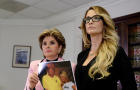 Lawyer Gloria Allred, left, holds a photograph of Jessica Drake and Donald Trump, taken in 2006 at a golf tournament in Lake Tahoe, California, after she spoke to reporters about allegations of sexual misconduct against Trump in Los Angeles, California, O 