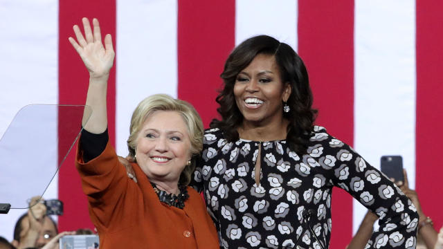 Democratic presidential candidate Hillary Clinton and first lady Michelle Obama greet supporters during a campaign event at the Lawrence Joel Veterans Memorial Coliseum Oct. 27, 2016, in Winston-Salem, North Carolina. 