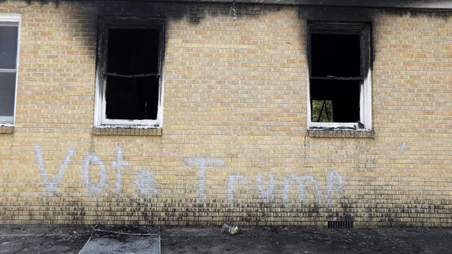 “Vote Trump” is spray-painted on the side of the fire-damaged Hopewell M.B. Baptist Church in Greenville, Miss., Nov. 2, 2016. 