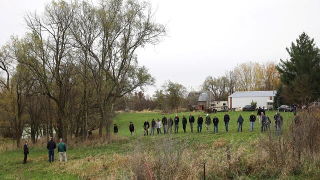 Investigators search a field near Redfield, Iowa, where the suspected gunman of two police officers who were shot and killed in separate attacks described as “ambush-style” in Urbandale and Des Moines, Iowa, turned himself in Nov. 2, 2016.