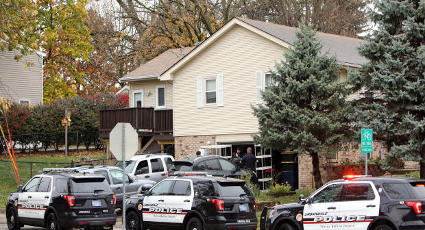 Urbandale police officers gather outside the home of Scott Michael Greene, the suspected gunman of two police officers who were shot and killed in separate attacks described as “ambush-style” in Urbandale and Des Moines, Iowa, Nov. 2, 2016. 