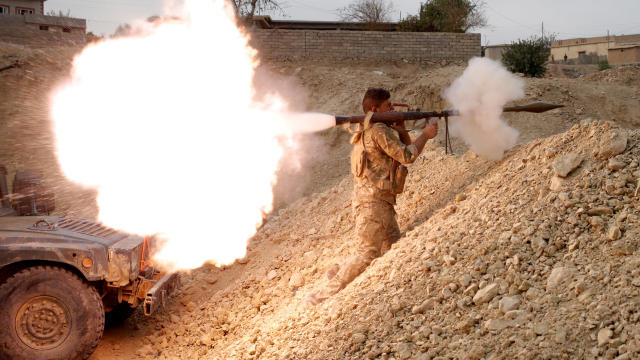 An Iraqi soldier fires a rocket-propelled grenade in Karamah, south of Mosul, Iraq, Nov. 10, 2016. 