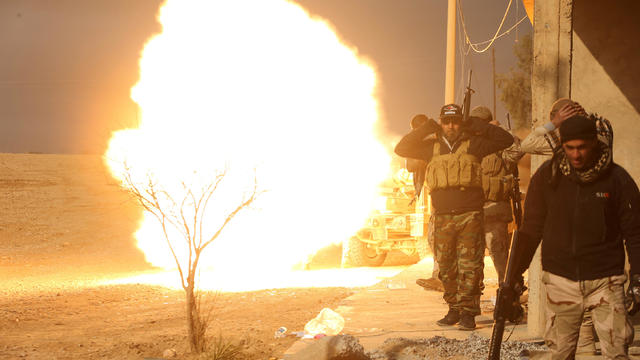 Iraqi forces backed by tribal militias fire artillery during battle to retake a village from the Islamic State of Iraq and Syria on the eastern bank of the river Tigris in Iraq Dec. 7, 2016. 