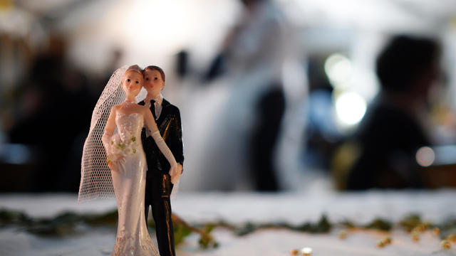 Bride and groom figurines are pictured on a table during a wedding party on Sept. 13, 2014, in Hede-Bazouges, a suburb of Rennes, France. 
