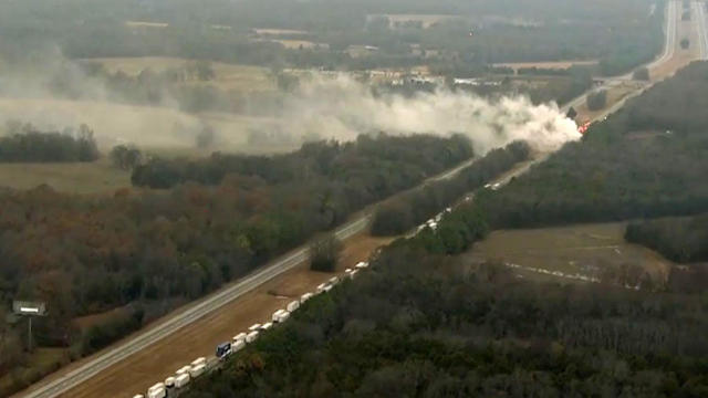 Smoke rises from where two semi-trucks were involved in a crash on Interstate 24 in Rutherford County, Tennessee, on Dec. 14, 2016. 