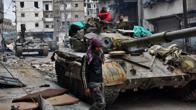 Syrian pro-government forces advance in the Jisr al-Haj neighborhood during the military operation to retake remaining rebel-held areas in the northern embattled city of Aleppo on Dec. 14, 2016. 
