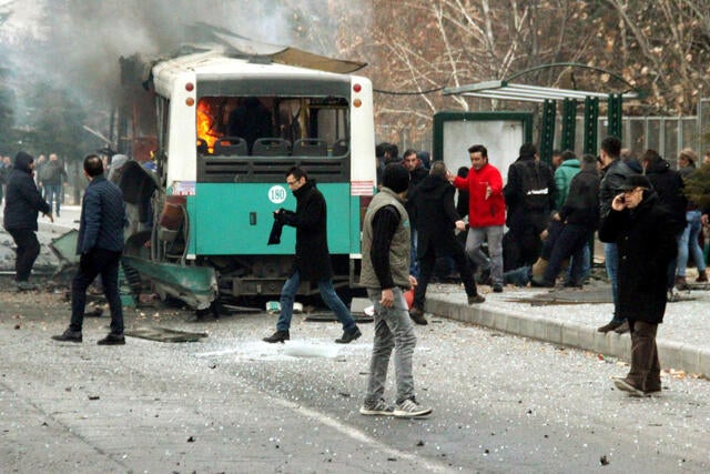 People react after a bus was hit by an explosion in Kayseri, Turkey, Dec. 17, 2016. 
