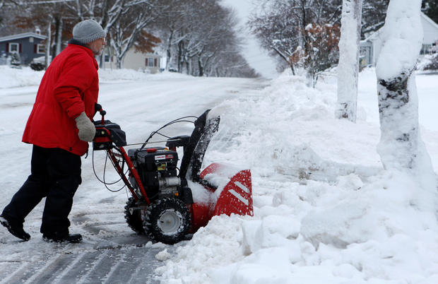 Tom Sargent pushes his snowblower up his driveway in Bangor, Maine, Dec. 30, 2016. 