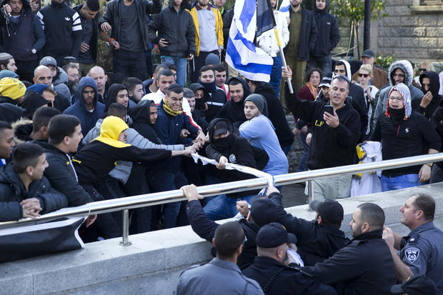 Right-wing supporters of Israeli soldier Sgt. Elor Azaria scuffle with police outside the Israeli military court in Tel Aviv, Israel, Jan. 4, 2017. 