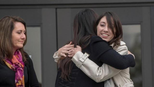 Michelle Susan Hadley, right, hugs Orange County District Attorney Chief of Staff Susan Kang Schroeder after being cleared of all charges in a complicated plot to frame her in Fullerton, Calif., Jan. 9, 2017. Her mother, Suzanne Hadley, is at left. 