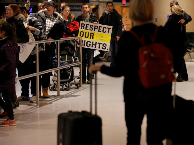 Demonstrators protesting President Trump’s travel ban executive order greet arriving passengers at Logan Airport in Boston Jan. 28, 2017. 