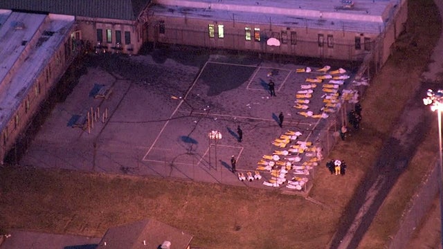 Inmates lie on the ground at James T. Vaughn Correctional Center in Smyrna, Delaware, on Feb. 2, 2017, after a disturbance that started a day earlier. 