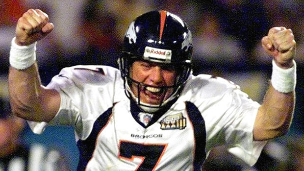 Denver Broncos quarterback John Elway pumps his fi 