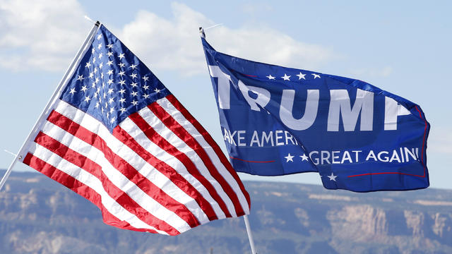 With the Colorado National Monument in the background, an American flag and a Trump campaign flag fly at a rally where then-Republican presidential nominee Donald Trump was going to speak on Oct. 18, 2016, in Grand Junction, Colorado. 