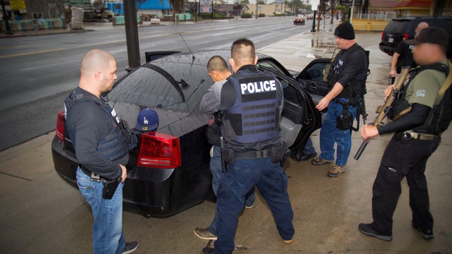 U.S. Immigration and Customs Enforcement (ICE) officers detain a suspect as they conduct a targeted enforcement operation in Los Angeles, California, on Feb. 7, 2017. 