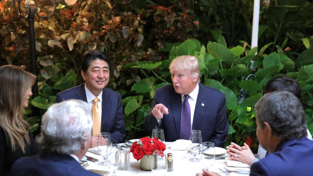 Japanese Prime Minister Shinzo Abe and Akie Abe, right, partially obscured, attend dinner with President Trump, his wife Melania and Robert Kraft, second left, owner of the New England Patriots, at Mar-a-Lago Club in Palm Beach, Florida, Feb. 10, 2017. 