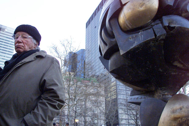 German artist Fritz Koenig stands next to his bronze sculpture “The Sphere” after a dedication ceremony in New York on March 11, 2002. 
