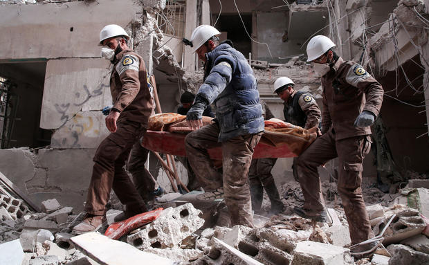 Syrian civil defense volunteers, known as the White Helmets, search for survivors following a reported government airstrike on the rebel-held neighborhood of Tishrin, on the northeastern outskirts of the capital Damascus, on Feb. 22, 2017. 