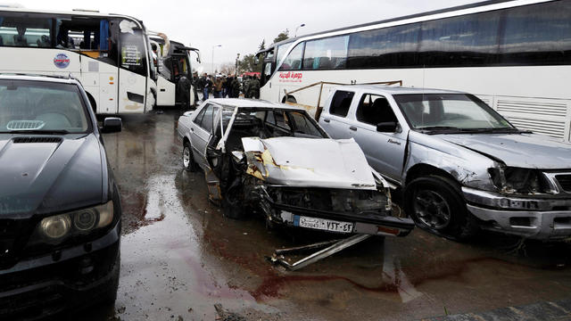 Damaged vehicles are pictured at the site of an attack by two suicide bombers in Damascus, Syria, March 11, 2017. 