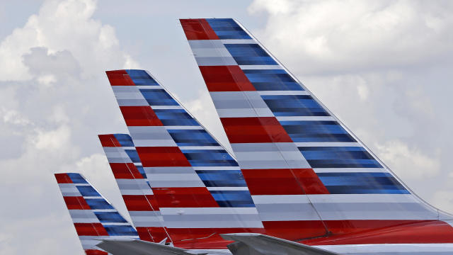 The tails of four American Airlines passenger planes are seen at Miami International Airport in Miami on July 17, 2015. 