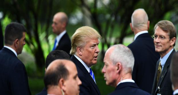 Then-Republican presidential nominee Donald Trump is surrounded by members of the Secret Service as he visits the tomb of former President Gerald Ford in Grand Rapids, Michigan, on Sept. 30, 2016. 
