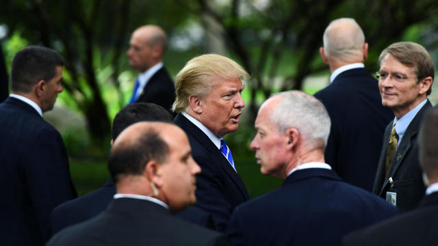 Then-Republican presidential nominee Donald Trump is surrounded by members of the Secret Service as he visits the tomb of former President Gerald Ford in Grand Rapids, Michigan, on Sept. 30, 2016. 