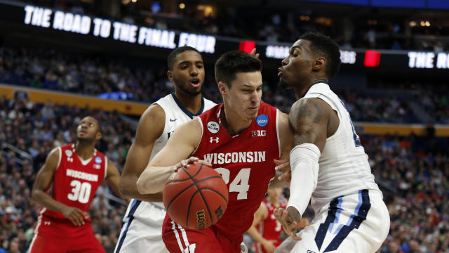 Wisconsin Badgers guard Bronson Koenig (24) tries to drive against Villanova Wildcats forward Darryl Reynolds (45) in the second half during the second round of the 2017 NCAA Tournament at KeyBank Center in Buffalo, New York, on March 18, 2017. 