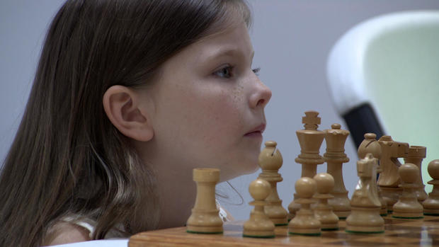 little-girls-face-next-to-chess-pieces.jpg 