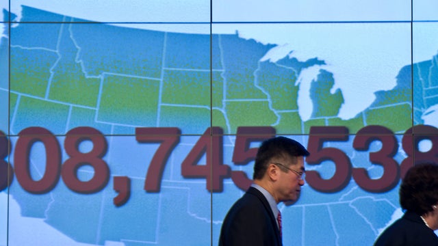 Then-U.S. Commerce Secretary Gary Locke and Acting Deputy Commerce Secretary Rebecca Blank walk past the figure of the U.S. population during a press conference to present the first set of 2010 Census data at the National Press Club in Washington on Dec. 