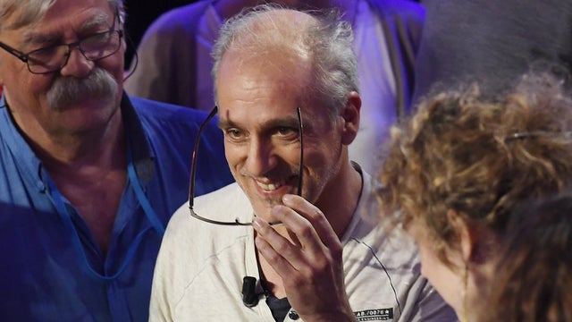 Presidential candidate for the far-left New Anticapitalist Party Philippe Poutou smiles as he arrives for a television debate at French private TV channels BFM TV and CNews, in La Plaine-Saint-Denis, outside Paris, France, April 4, 2017. 
