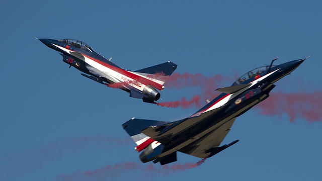 Two Chinese J-10 aircraft from the People's Liberation Army Air Force cross each other during the combined exercise Falcon Strike 2015 at the Wing 1 Korat air base in Korat, Thailand, on Nov. 24, 2015. 