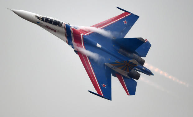 A member of the Russian air force's Knights aerobatic team performs in a SU-27 jet during a test flight ahead of an airshow in Zhuhai, China, on Nov. 10, 2014. 