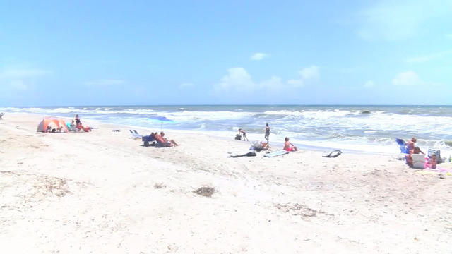 Beachgoers spend a day at the beach in Atlantic Beach, North Carolina. 