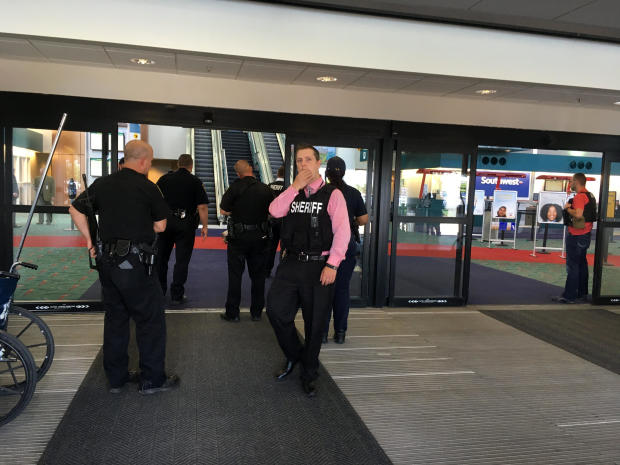 Police officers gather at a terminal at Bishop International Airport June 21, 2017, in Flint, Michigan, after an airport police officer was stabbed. 