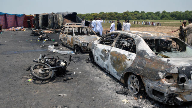 Burned-out cars and motorcycles are seen at the scene of an oil tanker explosion in Bahawalpur, Pakistan, June 25, 2017. 