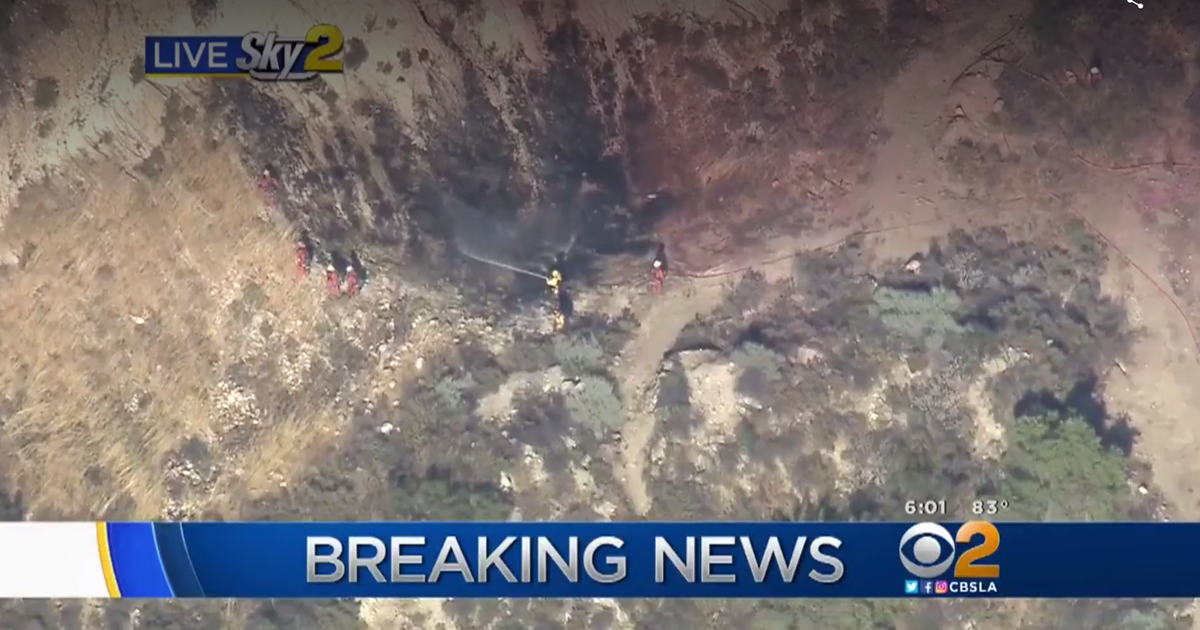 Freeway car crash sparks fire near Los Angeles - CBS News