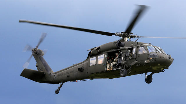 U.S. Army soldiers get ready to land a Black Hawk helicopter during an exercise in Mikyciai, Lithuania, June 17, 2017. 