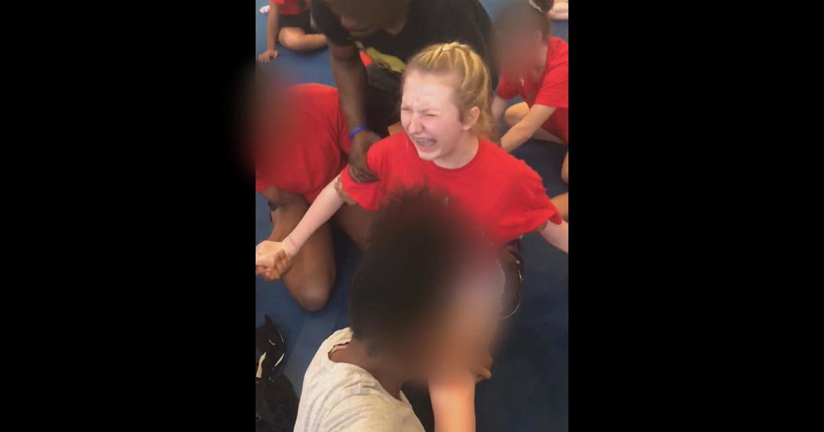 Cheerleading coach fired after being caught on video forcing teens into splits - CBS News