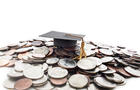 Graduation cap on money pile 