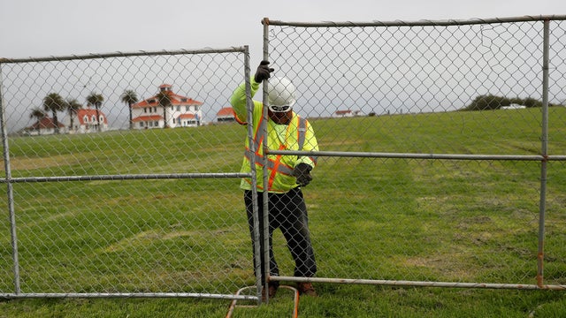 A worker installs a fence at Crissy Field in anticipation of Saturday's Patriot Prayer rally and counter demonstration in San Francisco, California 