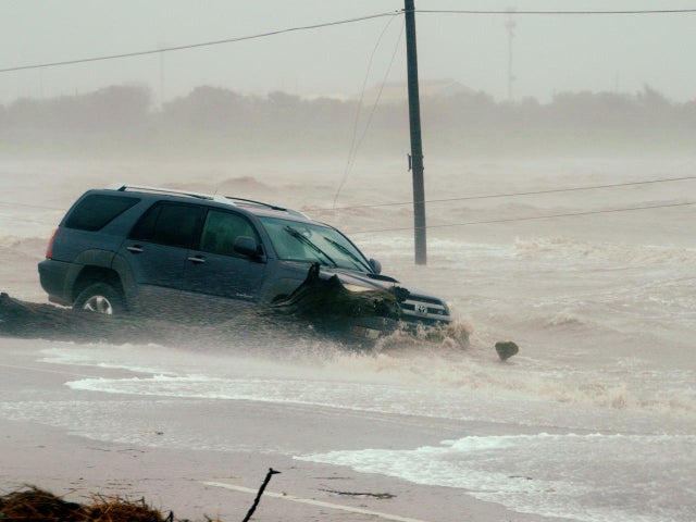 A car is surrounded by floodwaters from Hurricane Harvey in Point Comfort 